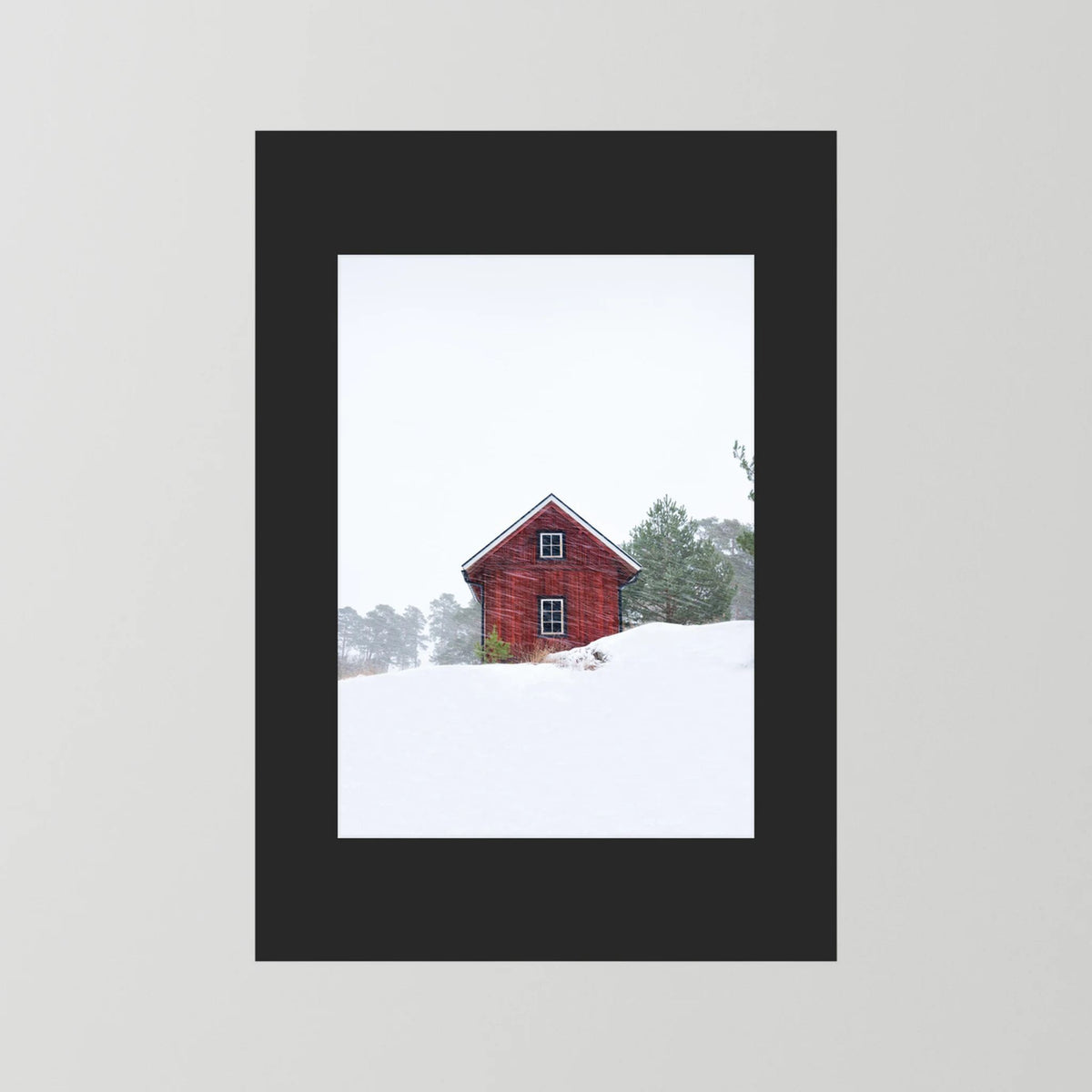 Old red house during snowstorm 