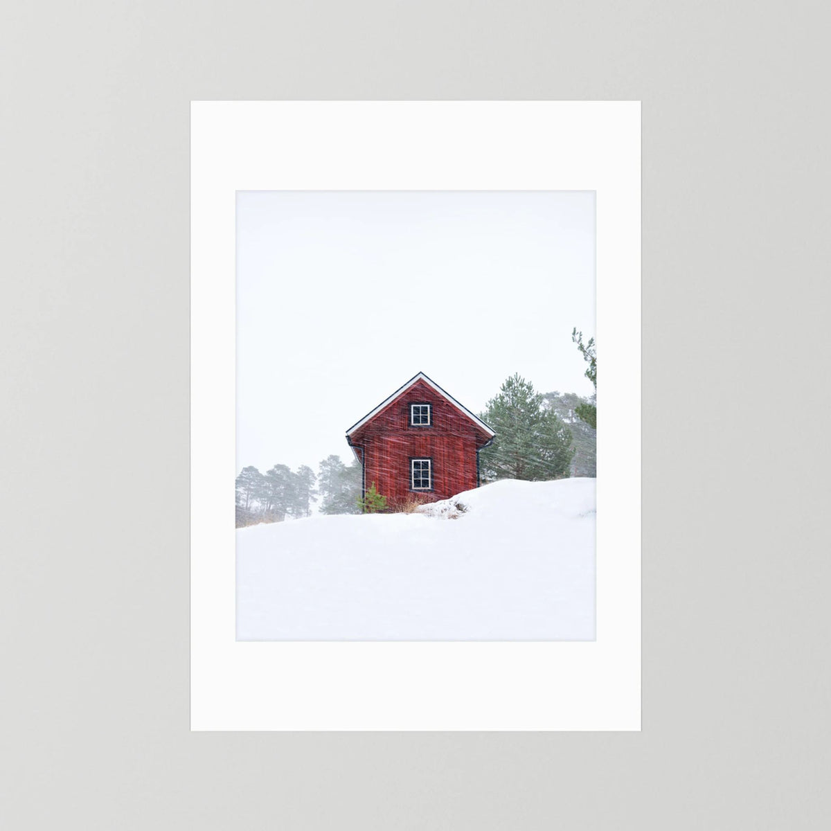 Old red house during snowstorm 