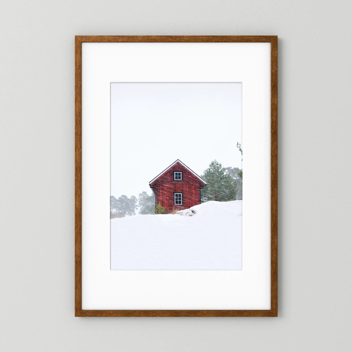 Old red house during snowstorm 