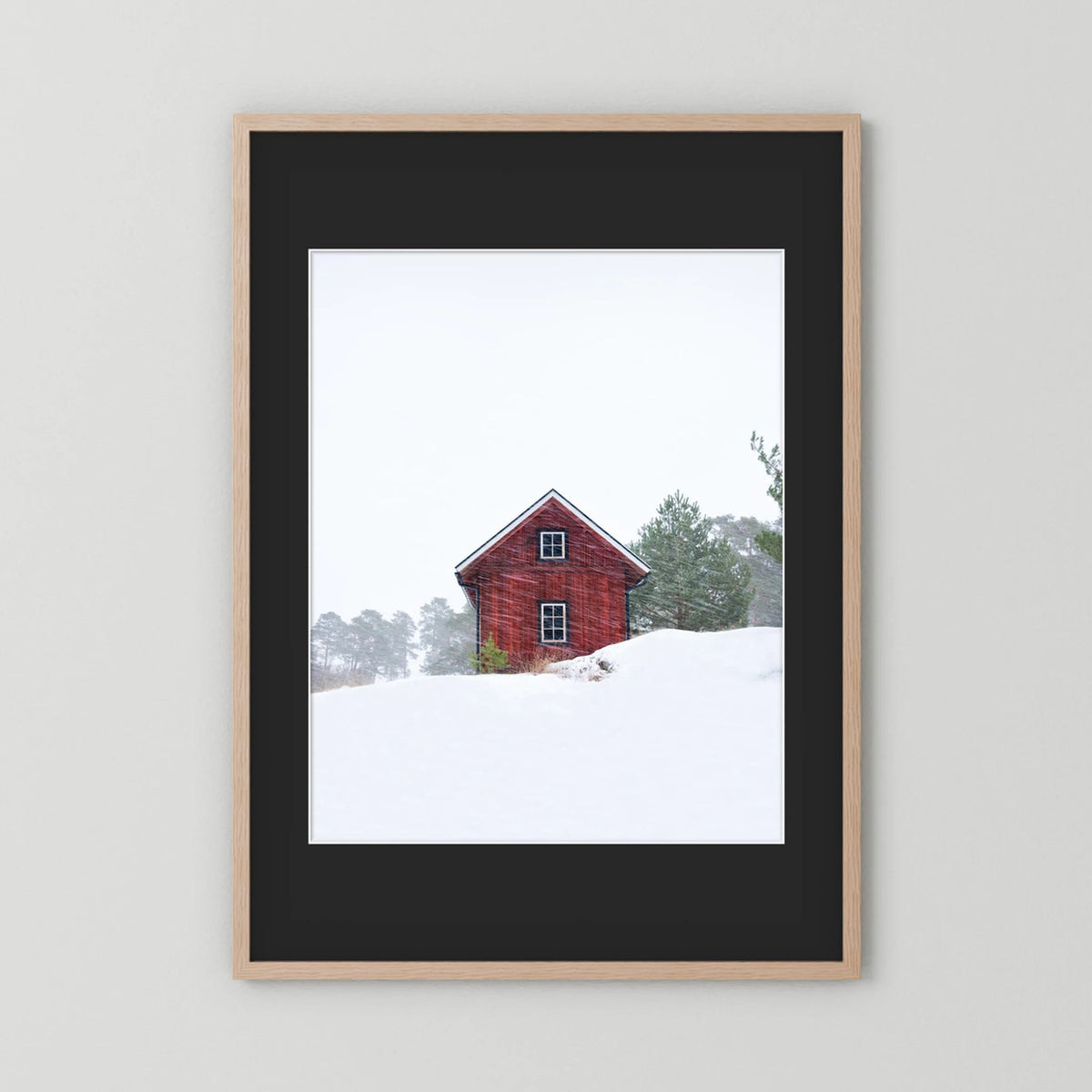 Old red house during snowstorm 