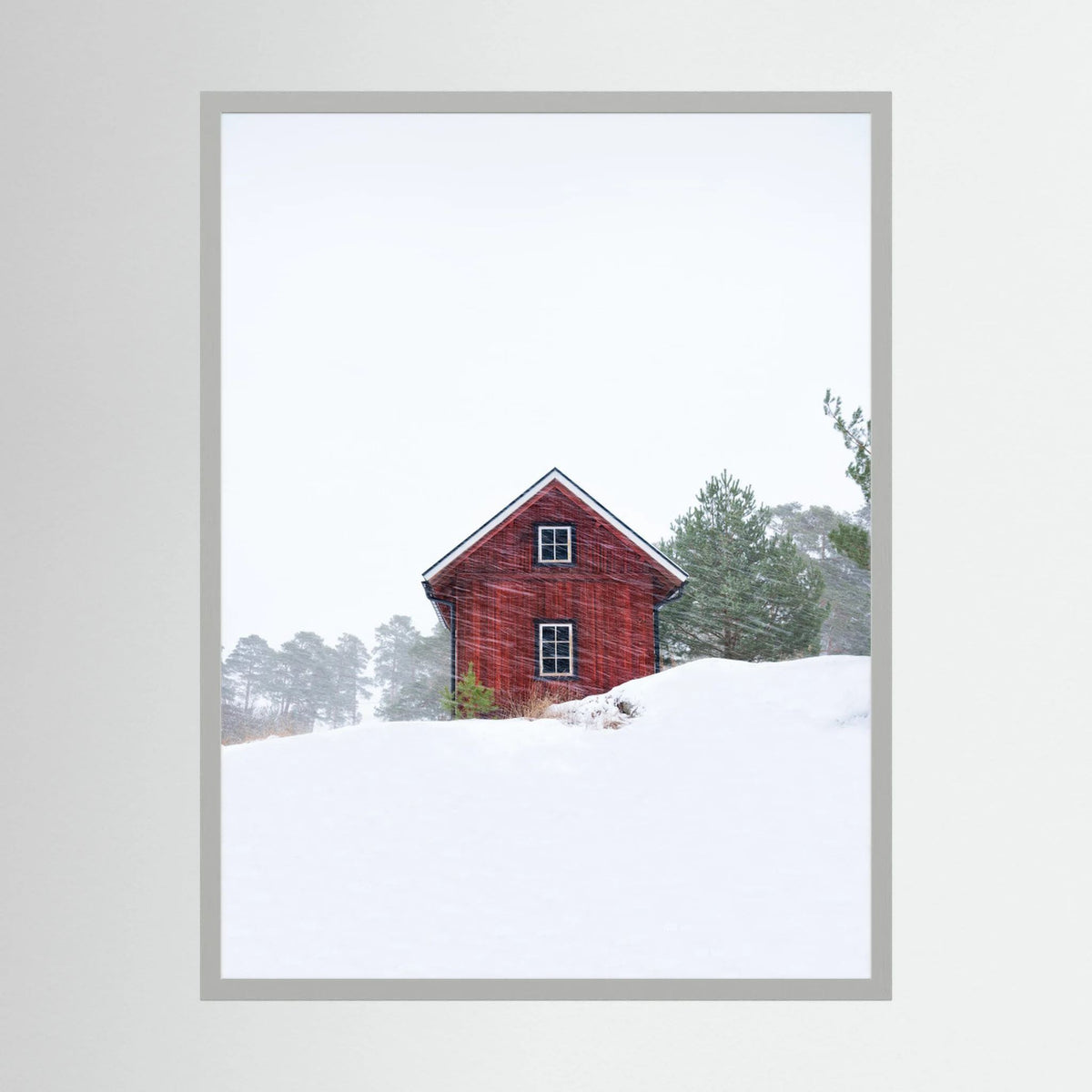 Old red house during snowstorm 