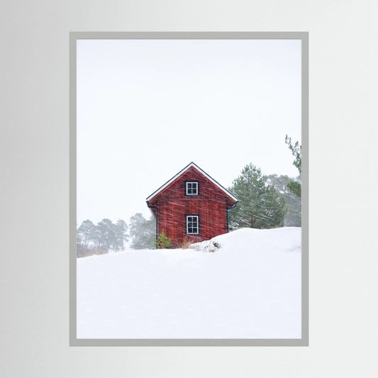 Old red house during snowstorm 