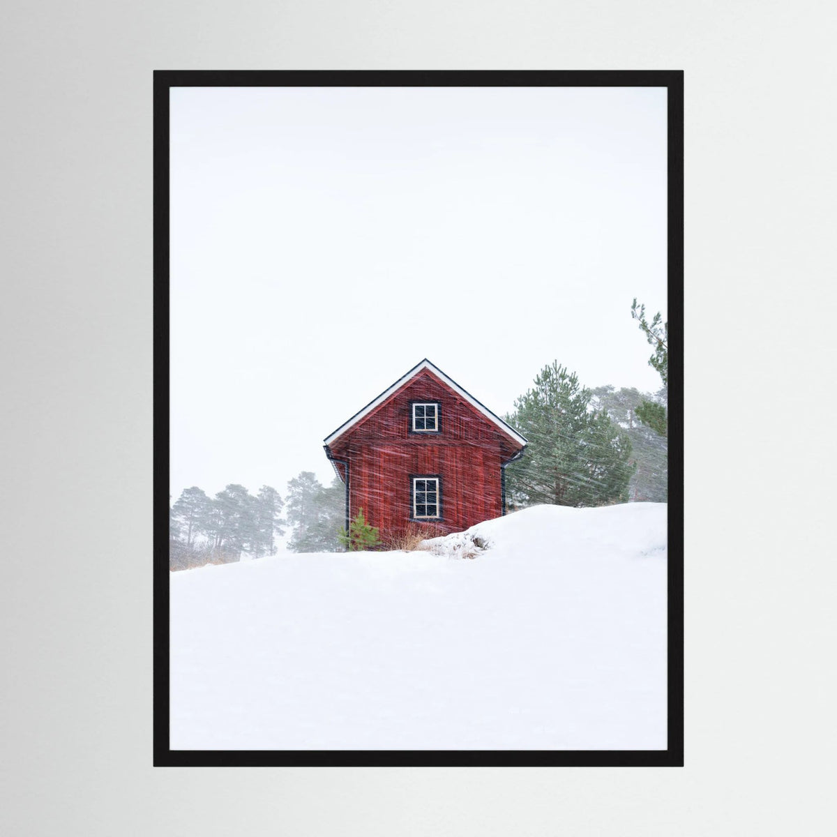 Old red house during snowstorm 