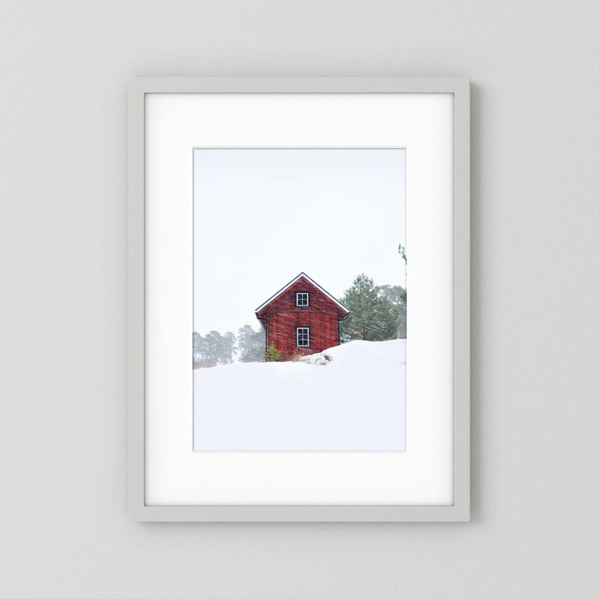 Old red house during snowstorm 