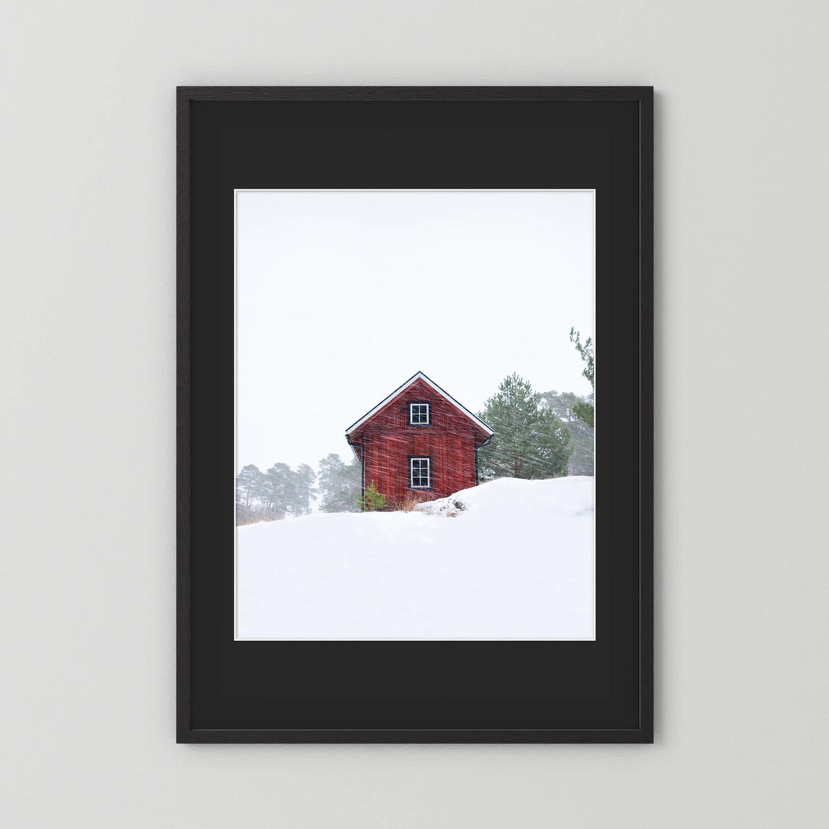 Old red house during snowstorm 