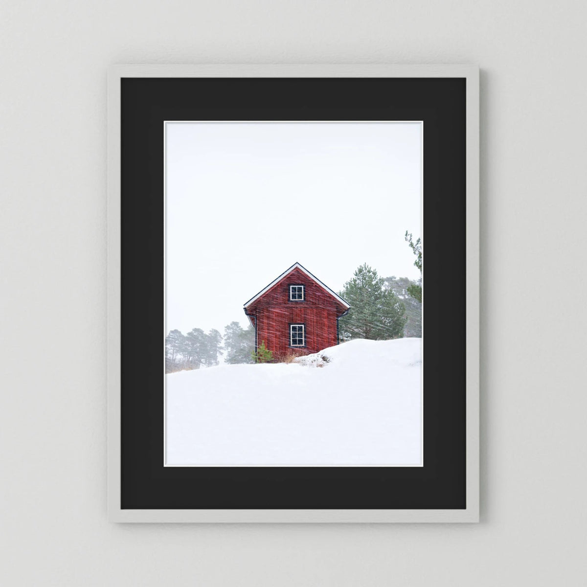 Old red house during snowstorm 
