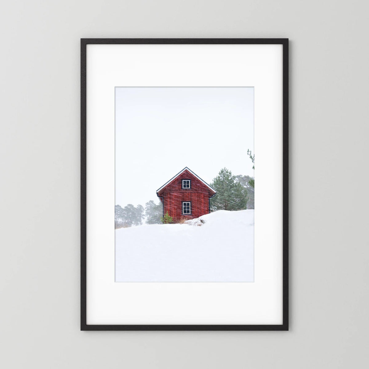 Old red house during snowstorm 