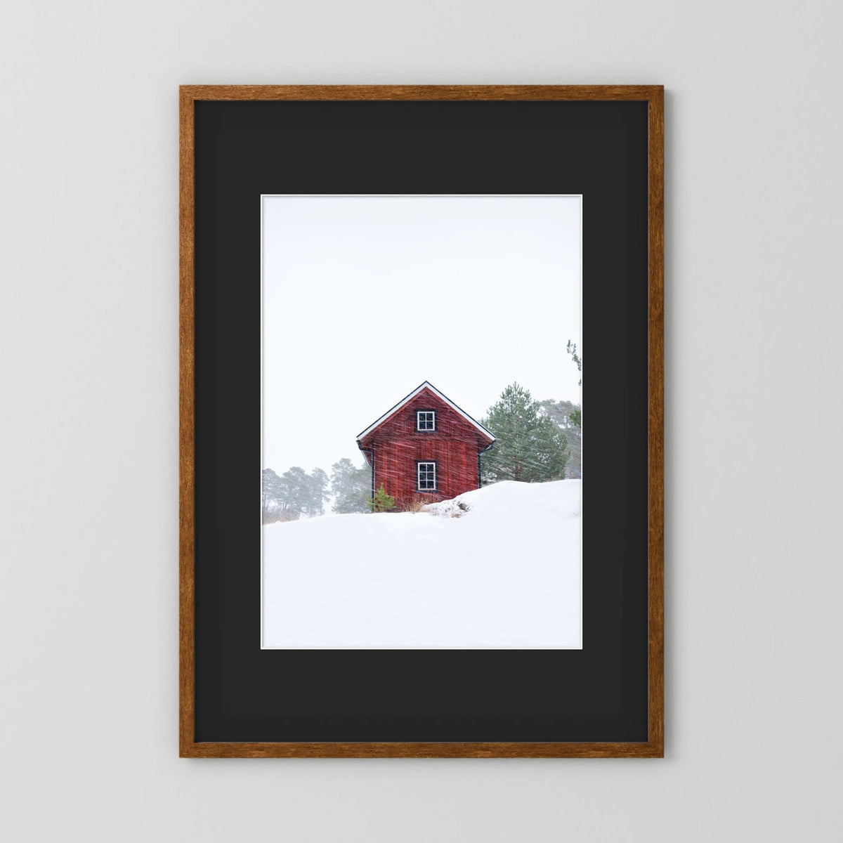 Old red house during snowstorm 