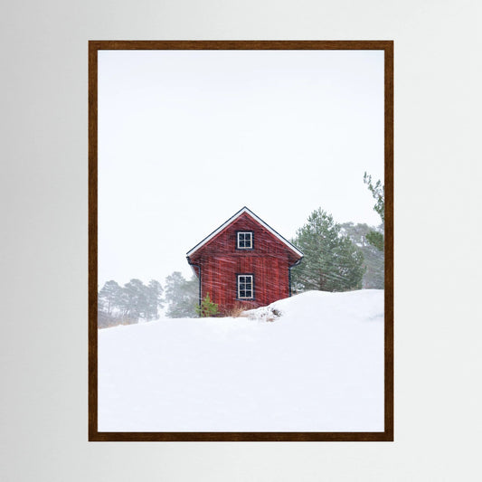 Old red house during snowstorm 