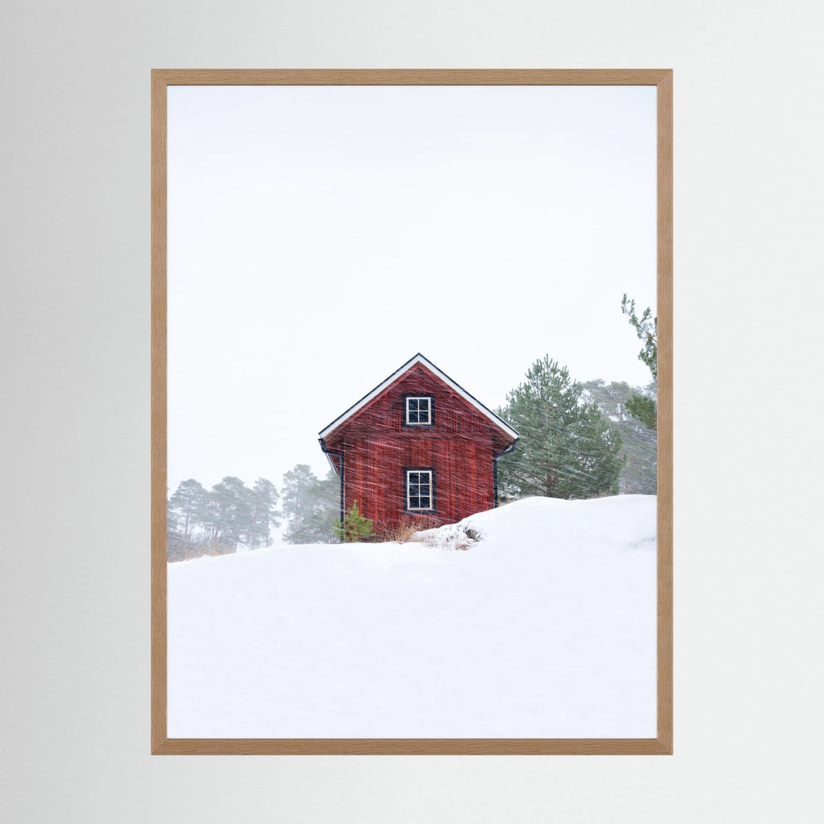 Old red house during snowstorm 