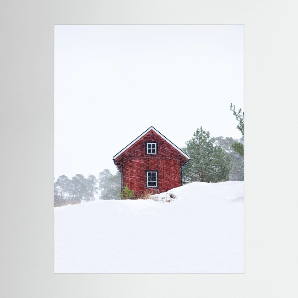 Old red house during snowstorm 