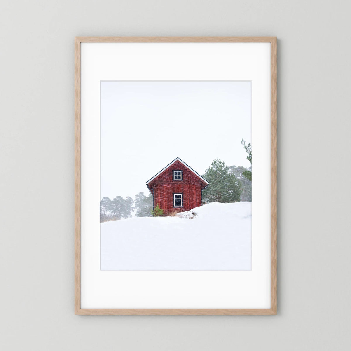 Old red house during snowstorm 